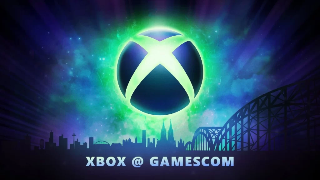 ogotipo iluminado do Xbox flutua sobre uma paisagem urbana estilizada de Colônia, Alemanha, com destaque para a catedral e ponte Hohenzollern, ao fundo de um céu nebuloso em tons de verde, azul e roxo. Texto abaixo diz "Xbox @ Gamescom".