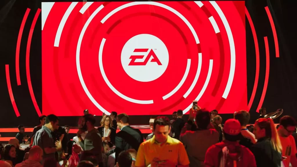 Logotipo da EA em um estande iluminado em evento de games.