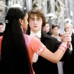 Cena de Harry Potter e o Cálice de Fogo mostrando Harry dançando no Baile de Inverno, inspirado no Torneio Tribruxo, ao lado de outros estudantes em trajes de gala.