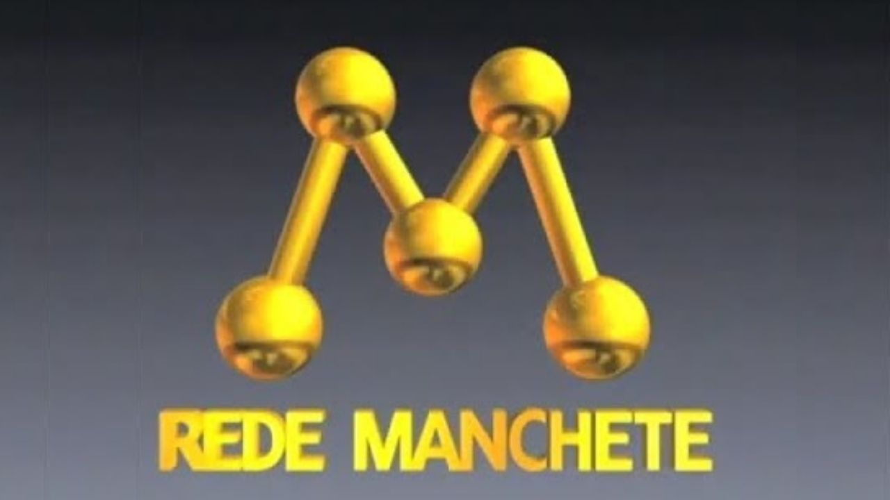 Logo clássico da Rede Manchete em dourado, exibido em fundo cinza, com a letra “M” formada por esferas conectadas.