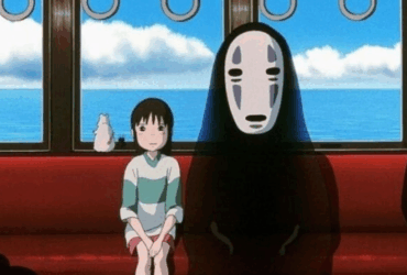 Cena icônica de A Viagem de Chihiro, com Chihiro e Sem-Rosto no trem — Studio Ghibli