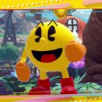 Imagem do remake PAC-MAN WORLD 2 Re-PAC mostrando o personagem Pac-Man em um ambiente colorido com árvores, moinho de vento e flores.