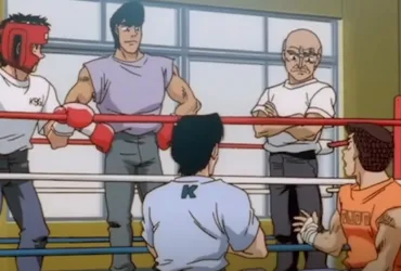 Cena do anime Hajime no Ippo mostrando um treino no ginásio de boxe: Ippo com luvas em um ringue, conversando enquanto Nakamura e outros membros do time observam ao redor.
