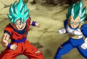 Goku e Vegeta em Dragon Ball Super com cabelo azul (Super Saiyajin Blue), lado a lado em um cenário rochoso, com postura de combate e expressão determinada.