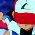 Ash Ketchum segurando uma Pokébola com a cabeça baixa após uma derrota, expressão abatida, representando o custo emocional da insistência e a dificuldade de parar